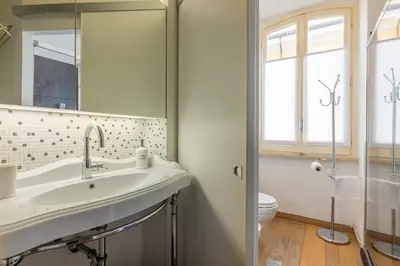 a bathroom with a sink and a toilet at Elegant Diocleziano Suite in Rome