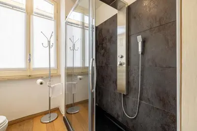 a bathroom with a shower with a glass door at Elegant Diocleziano Suite in Rome
