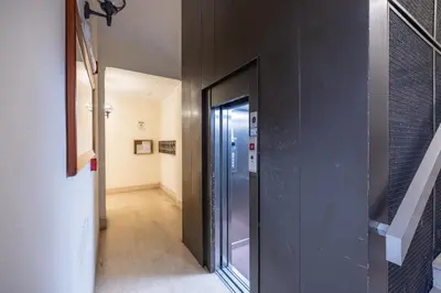 a hallway with a glass door in a building at Elegant Diocleziano Suite in Rome