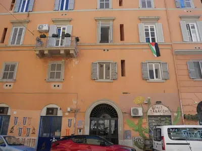 a parking lot in front of a building with graffiti at Metro Roma Termini - Love in Loft in Rome