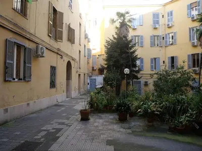 an orange building with blue and black windows at Metro Roma Termini - Love in Loft in Rome