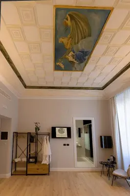 a room with a ceiling with a painting on it at Villa Borghese Prestige Rooms in Rome