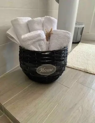 a basket filled with towels on top of a floor at Fefe's House in Rome