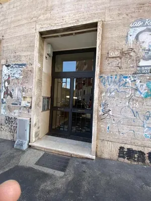 a building with graffiti on the side of it at Fefe's House in Rome