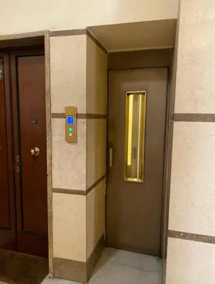an elevator with a door and a window in a building at Fefe's House in Rome