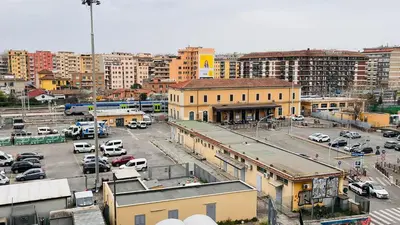 a city with cars parked in a parking lot at Fefe's House in Rome