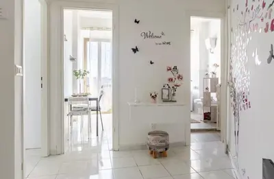 a room with a hallway with white walls and a table at Fefe's House in Rome
