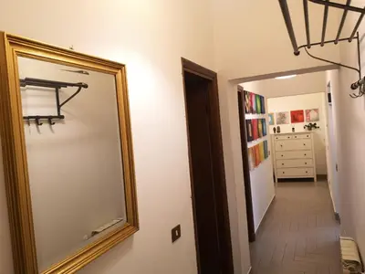 a mirror on a wall next to a hallway at Gio's home in Rome