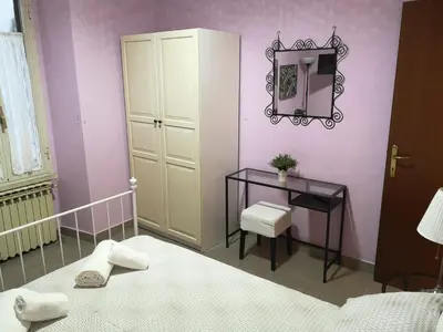 a bedroom with a bed and a mirror and a table at Gio's home in Rome