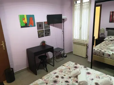 a bedroom with a desk and a bed and a deskictericter at Gio's home in Rome