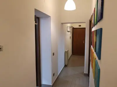 a hallway with white walls and a hallway with a door at Gio's home in Rome