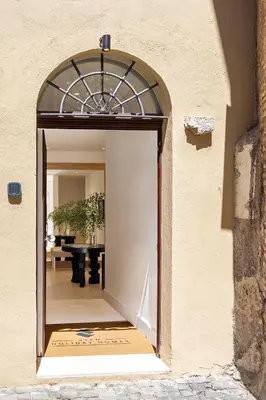 a doorway into a building with a table in the background at Viam Villa Futura in Rome