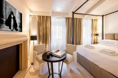 a bedroom with a bed and a table with chairs at Viam Villa Futura in Rome
