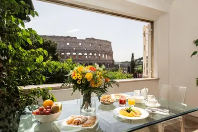 a table with food on it with a view of the city at 47Luxury Suites - Colosseo in Rome