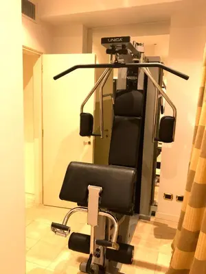 a gym with a chair in a room at 47Luxury Suites - Colosseo in Rome