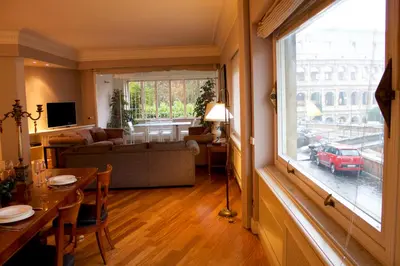 a living room with a couch and a table and a window at 47Luxury Suites - Colosseo in Rome