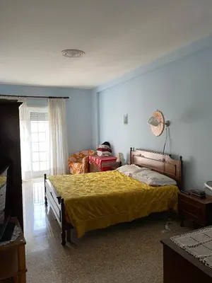 a bedroom with a bed with a yellow bedspread at Lacasadirosa in Rome