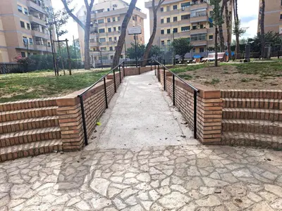 a walkway in a park with a fence at Lacasadirosa in Rome