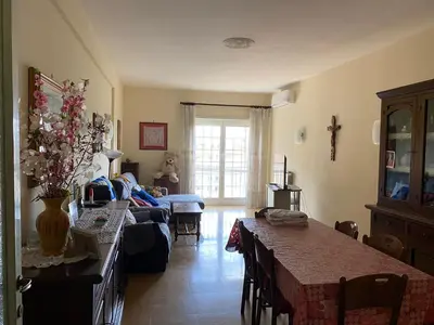 a living room with a table and a couch at Lacasadirosa in Rome
