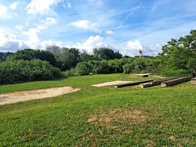 a park with benches in a grass field at Lacasadirosa in Rome