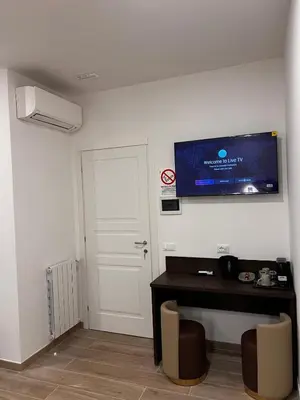a room with a desk and a tv on the wall at Garden Of Vatican's in Rome