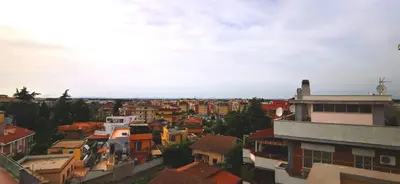 an aerial view of a city with buildings at Penthouse loft with view in Rome