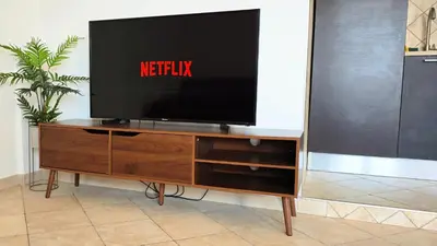 a flat screen tv on a wooden entertainment center at Penthouse loft with view in Rome
