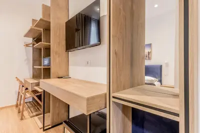 a small room with a desk and a tv at Coliseum sweet guest house in Rome