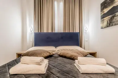 a bedroom with a bed with two pillows on it at Coliseum sweet guest house in Rome