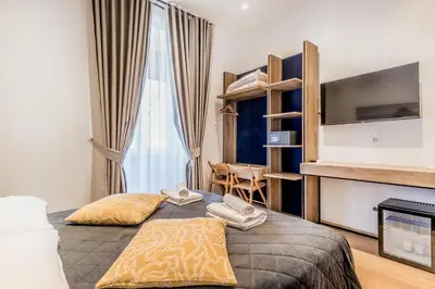 a bedroom with a bed with a tv and a window at Coliseum sweet guest house in Rome
