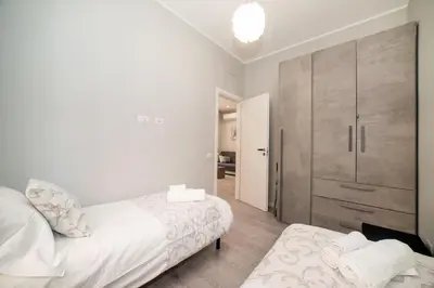 a bedroom with two beds and a large closet at Le Quattro Stagioni Vatican City in Rome