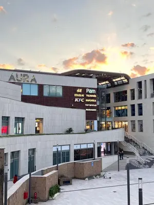 an office building with a sunset in the background at Le Quattro Stagioni Vatican City in Rome