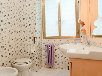 a bathroom with a toilet and a sink and a window at [Rome] House with garden near the Olympic Stadium in Rome