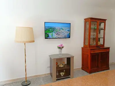 a corner of a room with a lamp and a dresser at [Rome] House with garden near the Olympic Stadium in Rome