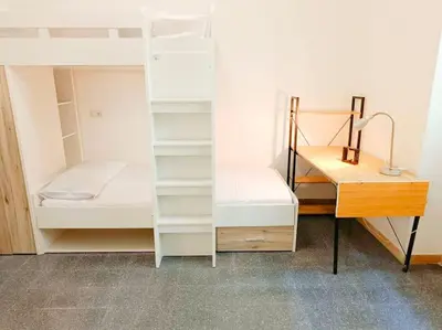 a room with two bunk beds and a desk at [Rome] House with garden near the Olympic Stadium in Rome