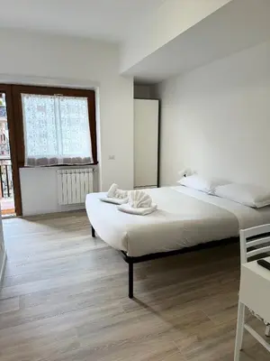a white room with a bed and a window at Cerreto Suite Housing in Rome