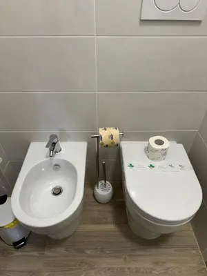 a small bathroom with a toilet and a sink at Cerreto Suite Housing in Rome