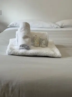 a pile of towels sitting on top of a bed at Cerreto Suite Housing in Rome