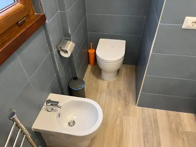 a small bathroom with a toilet and a sink at Cerreto Suite Housing in Rome