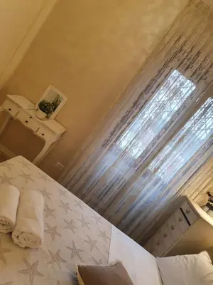 a bedroom with a bed with a window and towels at Crismi house in Rome
