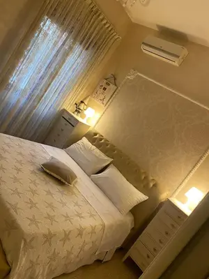 a bedroom with a white bed and a window at Crismi house in Rome
