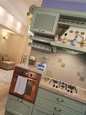 a kitchen with a stove top oven in a room at Crismi house in Rome