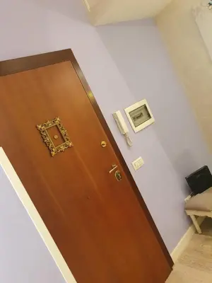 a wooden door with a picture on the wall at Crismi house in Rome