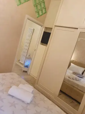 a bedroom with a mirror and a bed and a staircase at Crismi house in Rome