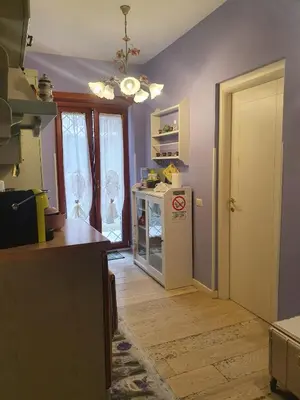 a kitchen with purple walls and a white refrigerator at Crismi house in Rome