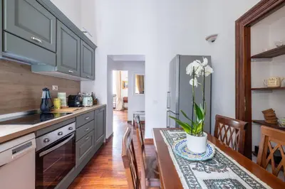 a kitchen with a table with a vase of flowers on it at Luxury apartment in the Heart of Rome - near metro A and B in Rome