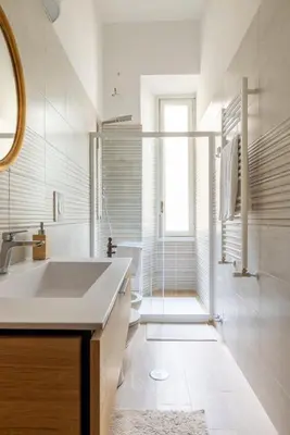 a white bathroom with a sink and a shower at Luxury apartment in the Heart of Rome - near metro A and B in Rome
