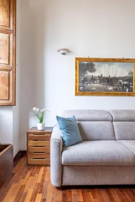 a living room with a couch and a painting on the wall at Luxury apartment in the Heart of Rome - near metro A and B in Rome