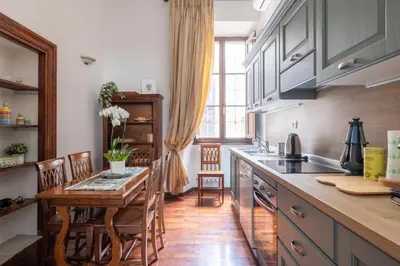 a kitchen with a wooden table and a dining room at Luxury apartment in the Heart of Rome - near metro A and B in Rome