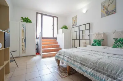 a bedroom with a large bed and a staircase at Dimora San Giovanni in Rome